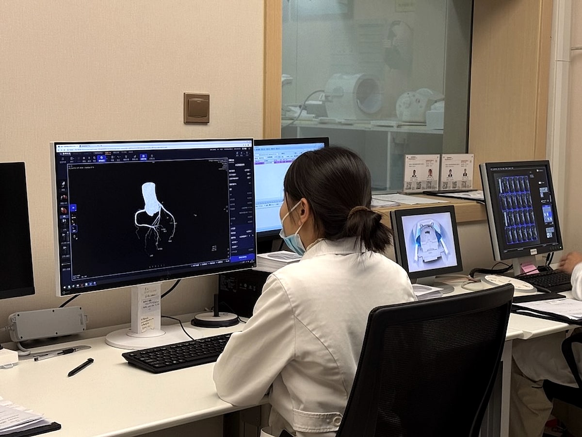 Clinicians reviewing diagnostic imaging files on medical monitors